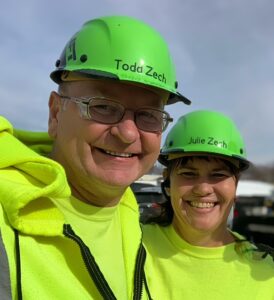Two adults wearing hard hats